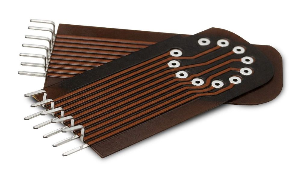 Polyimide-cored solder fingers on a flexible PCB. The tinned fingers are permanently formed; the traces lead to plated-through holes.